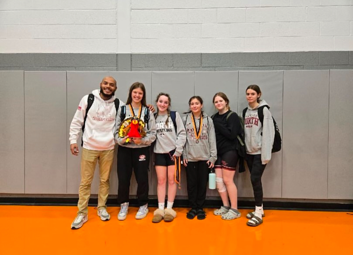 From left: Girls wrestling coach Dominick Sterr, Sophomore Viki Rodnikova, Junior Meryn Finnegan, Freshman Isabelle Chavez, Sophomore Siena Hart.